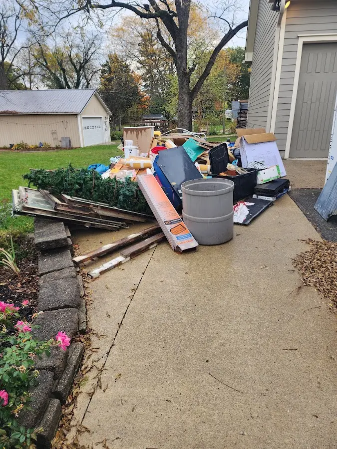 Dumpster being loaded with debris for Estate Cleanout Dumpster Rental in McCordsville
